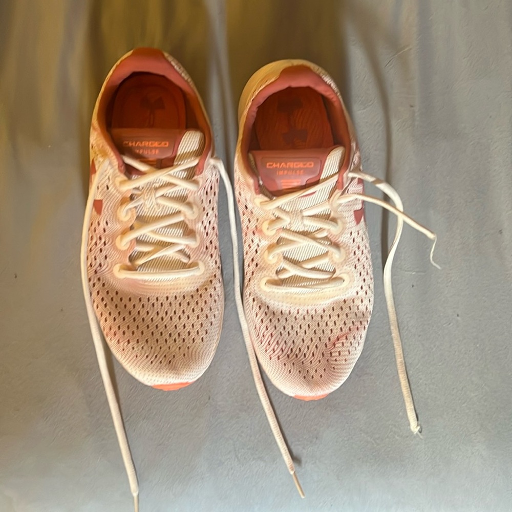 Under Armour Charged Impulse size 9, pink and white in color.